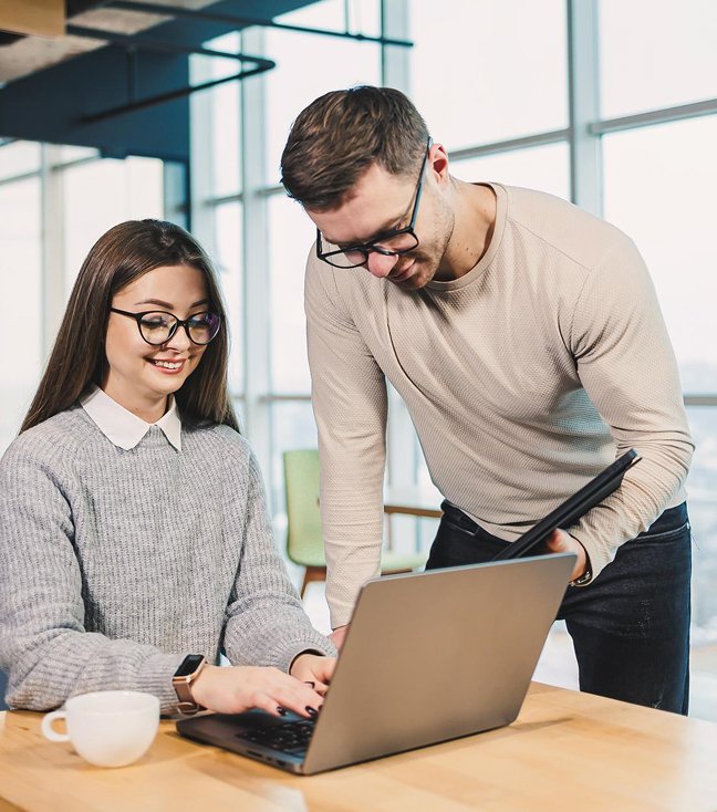 Team reviewing work together on a laptop